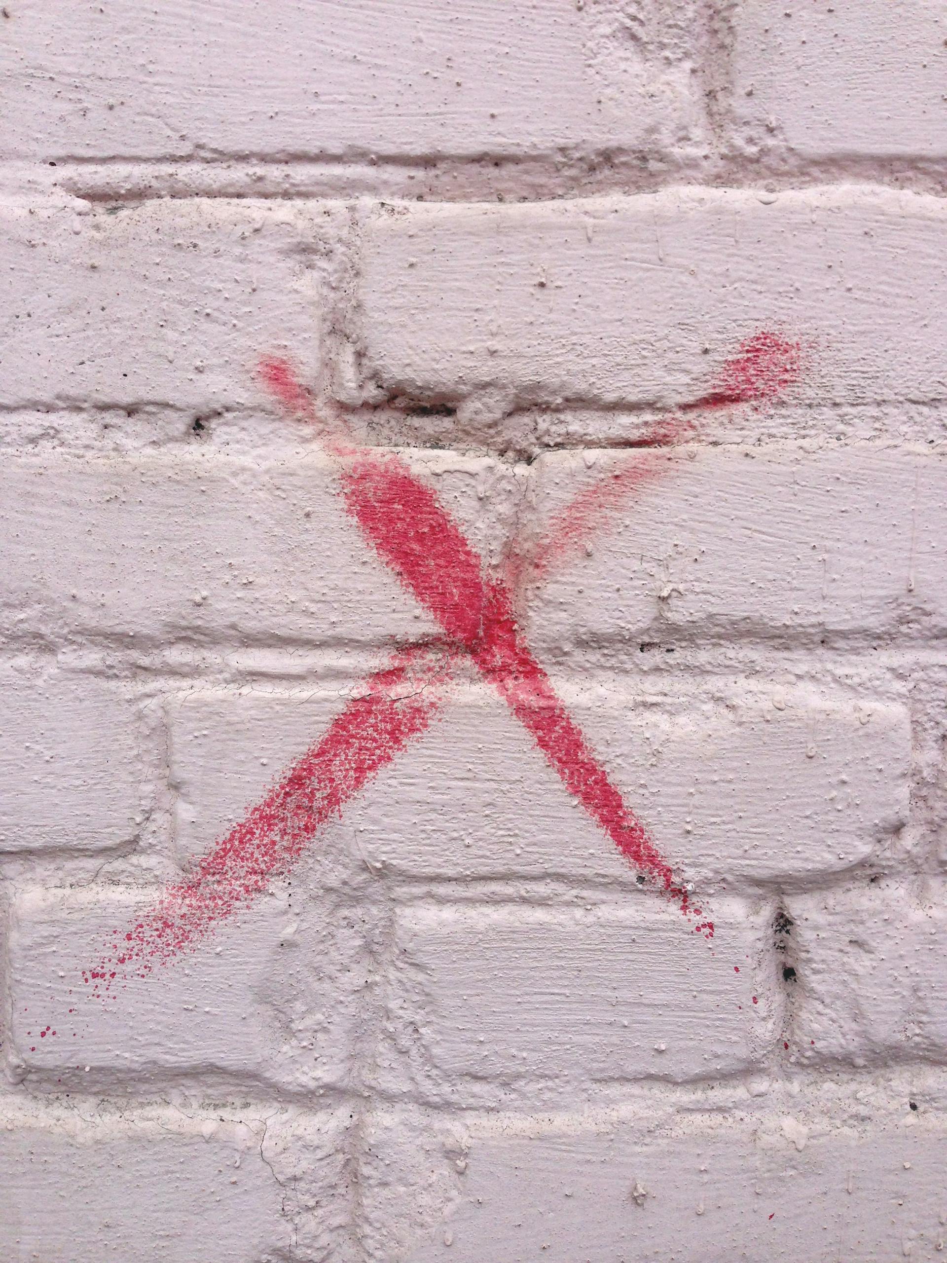 X sign on a wall