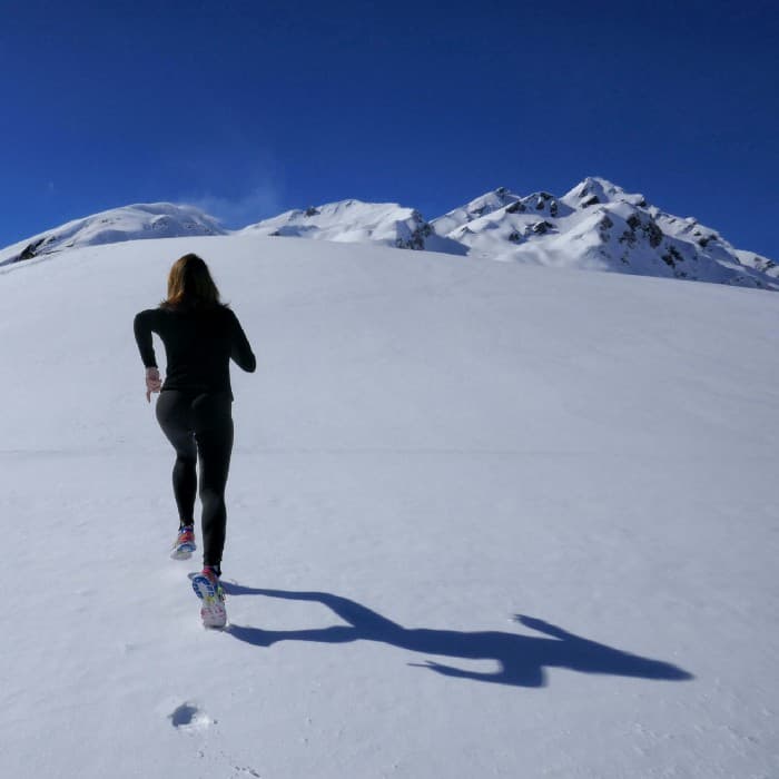 Woman running on a snow